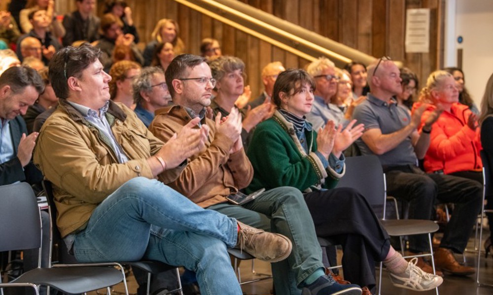 A group of people sitting in an auditorium